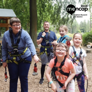 Children with learning disabilities smiling as they go on a woodland adventure with a supervisor