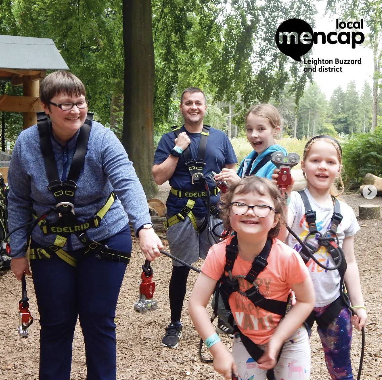 Children with learning disabilities smiling as they go on a woodland adventure with a supervisor